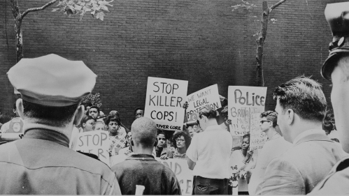 protestors marching with signs during the Harlem uprising of 1964