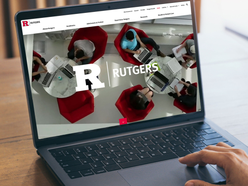 A person viewing the Rutgers website on a laptop