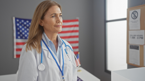 A physican with an American flag in the background