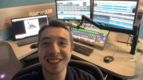 Rutgers senior Eddie Kalegi sits in front of a radio board at SiriusXM's headquarters in New York.