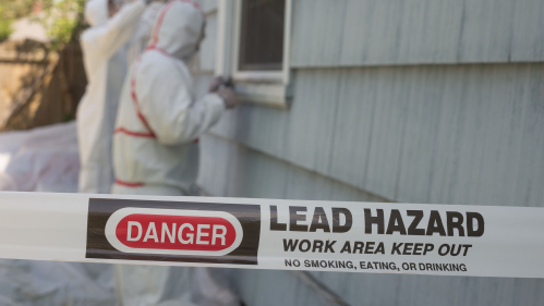 workers in haz-mat suits remove lead paint