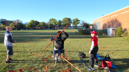 A student athlete throws a javelin