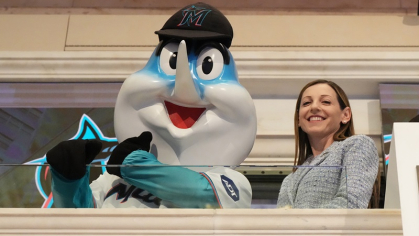 Alumna Caroline O’Connor standying with Miami Marlins mascot