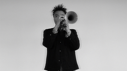 Trumpeter Takuya Kuroda performing on a black and white background