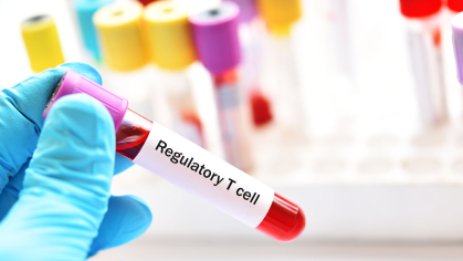 researcher holds vial of regulatory t cells