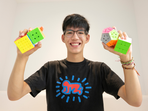 Luke Galioto holding Rubix Cubes