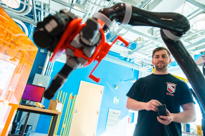 a student working with a robot in a lab