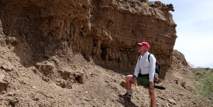 Man standing at the base of a mountain