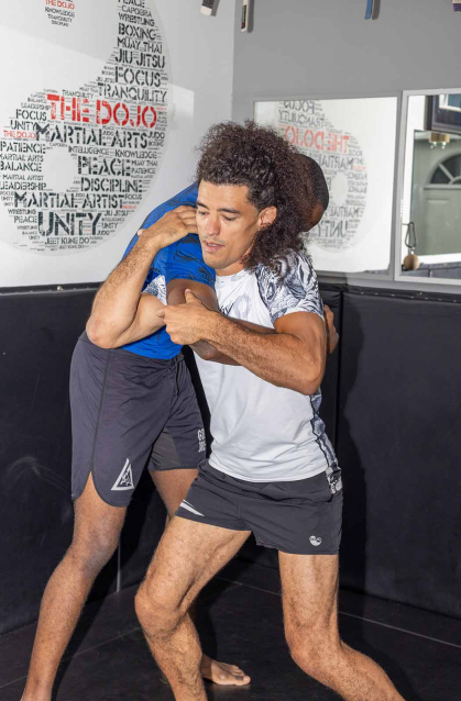 Michael Loureiro practices a throw with Rutgers medical student Yvan Yomba in Loureiro's dojo in the Ironbound neighborhood of Newark.