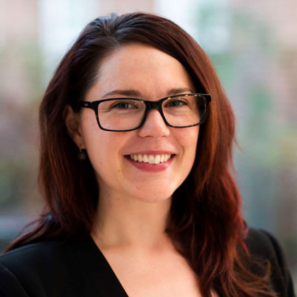 A woman with brown hair in a black sweater