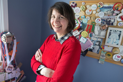 Amy Vojta pictured in her office with memorabilia from greek life on the walls