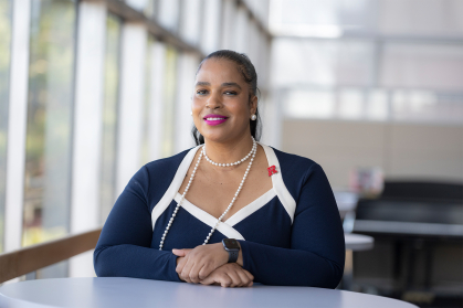 Karima Woodyard, Director, Student Involvement and Leadership, seated at a table