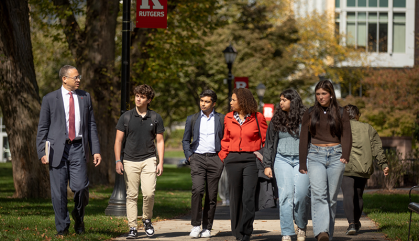 President Jonathan Holloway walks with Rutgers students